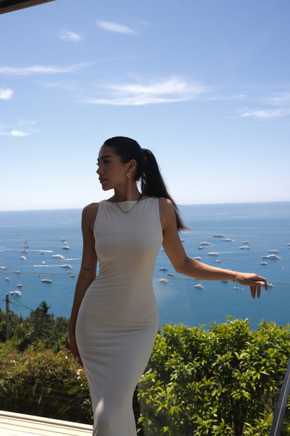 Woman on a balcony overlooking the coastline